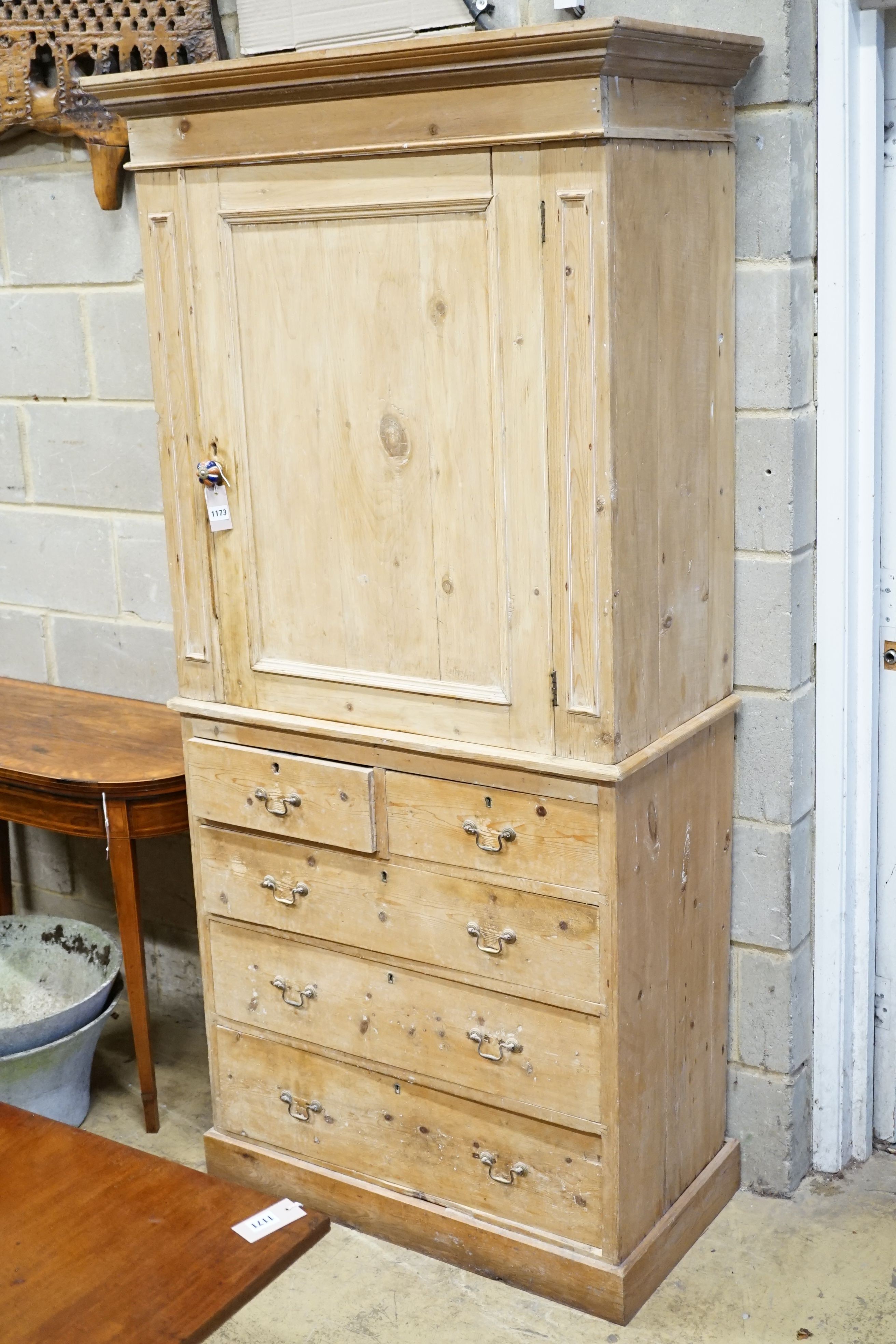 An Edwardian pine kitchen cupboard with five drawer base, width 94cm, height 193cm